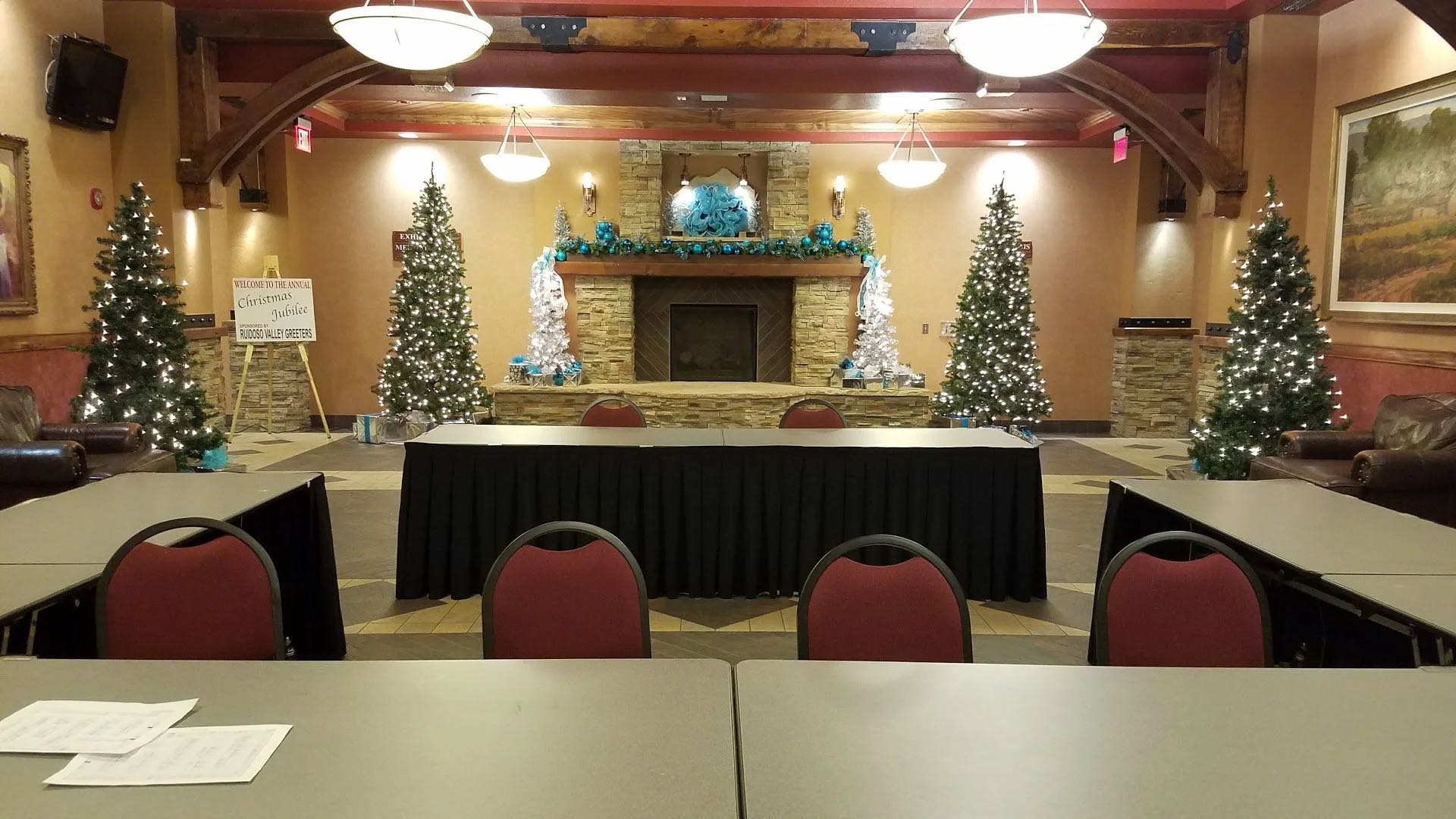 The lobby fireplace decorated with Christmas trees and blue-and-silver garland for the annual Christmas Jubilee, sponsored by the Ruidoso Valley Greeters.