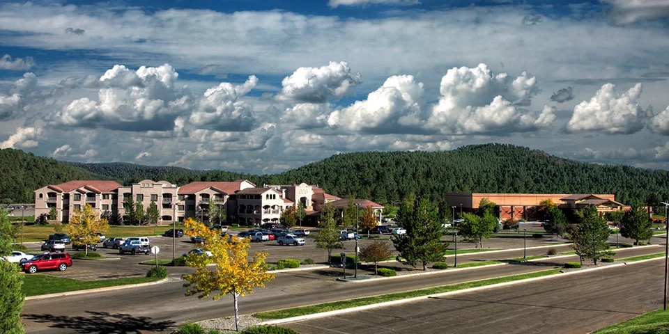 A distant elevated view of the adjacent hotel and the Convention Center under a dramatic cloud bank.
